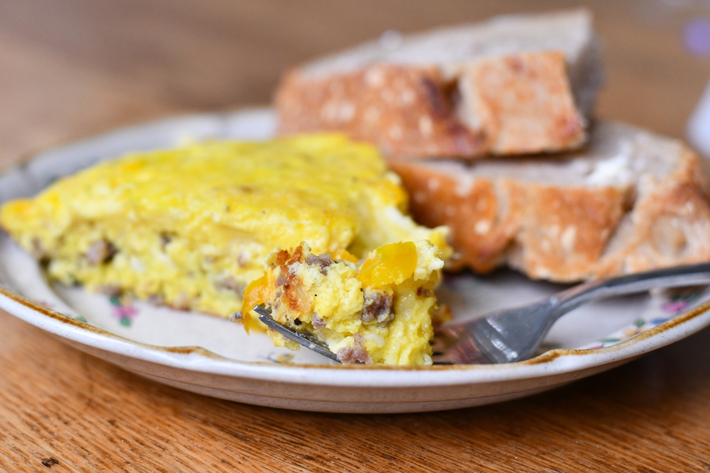 Photo of sausage and pepper frittata with sourdough bread. 